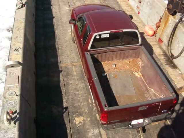 A maroon pickup truck parked on the Inlet Raider’s timber deck, seen from above