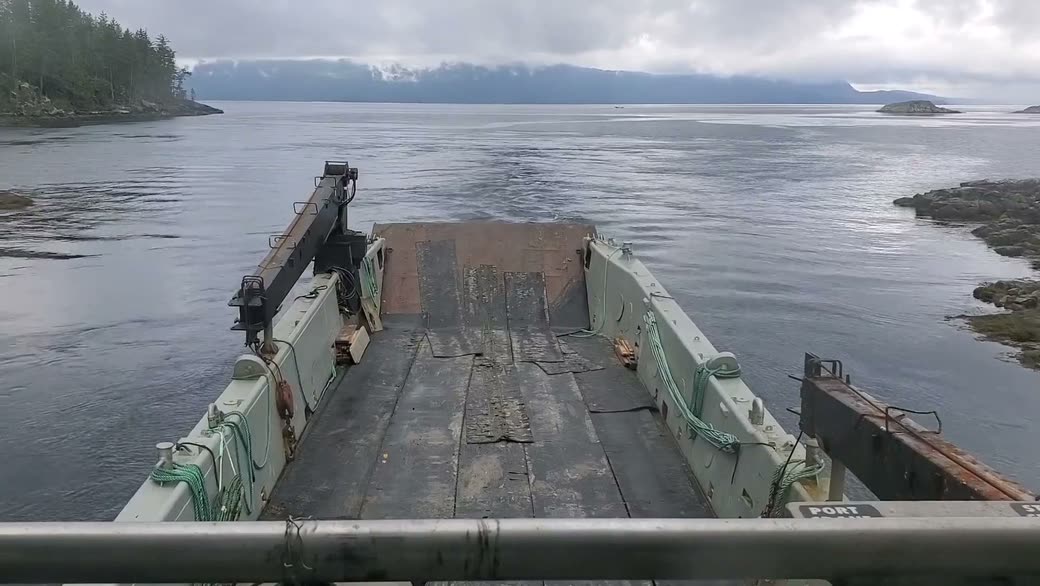 The open deck and bow ramp under cloud, islands and a long shoreline ahead